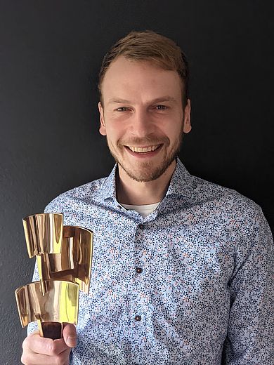 Johannes Wombacher mit Statue in der Hand