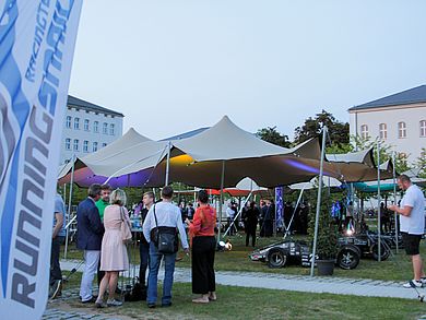 Menschen mit Getränken in der Hand auf dem Campus