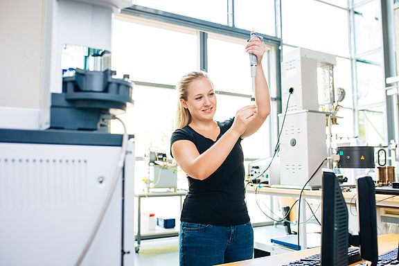 Studentin pipettiert im Labor eine Wasserprobe