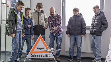 Gruppe Schüler mit Drohne