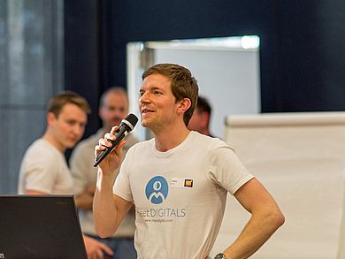 Tobias Walbert, meetDigitals, begrüßt die Teilnehmerinnen und Teilnehmer (Copyright: Martin Schuller).