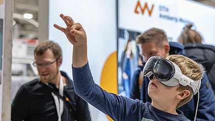 Enthusiasm for mixed reality: a young visitor immerses himself in a virtual representation of the human body