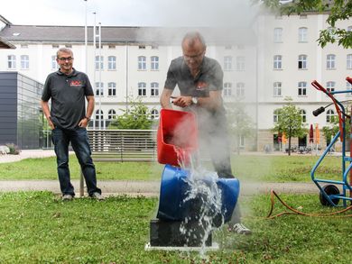 Andreas Weiß kippt Wasser über heißes Stahlfass