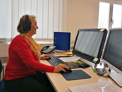 Frau vor PC-Bildschirm